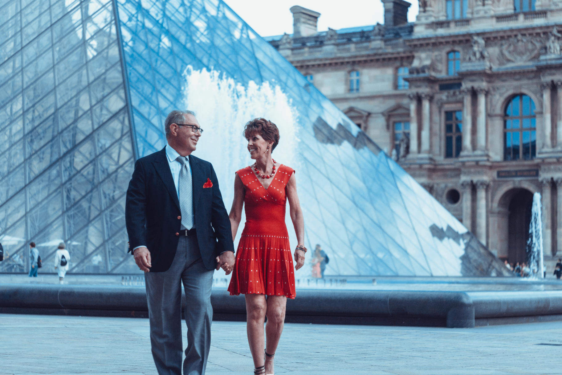 Larry and Fern Bensignor walking together at the Louvre in Paris